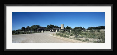 Framed Road leading towards the entrance of a rest camp, Okaukuejo, Etosha National Park, Kunene Region, Namibia Print