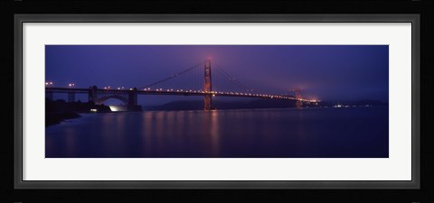Framed Suspension bridge lit up at dawn viewed from fishing pier, Golden Gate Bridge, San Francisco Bay, San Francisco, California, USA Print
