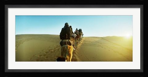 Framed Row of people riding camels through the desert, Sahara Desert, Morocco Print
