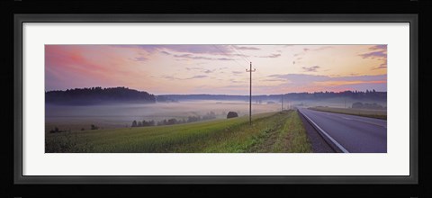 Framed Country road and telephone lines splitting farmlands at dawn, Finland Print
