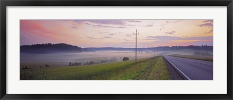 Framed Country road and telephone lines splitting farmlands at dawn, Finland Print