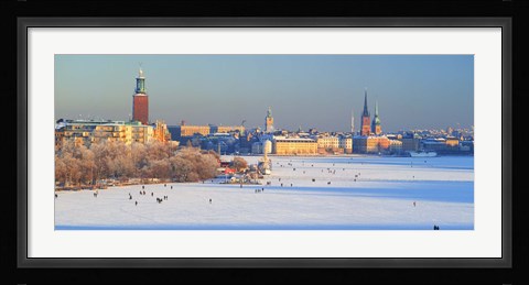Framed People strolling across frozen Riddarfjarden, Riddarholmen, Stockholm, Sweden Print