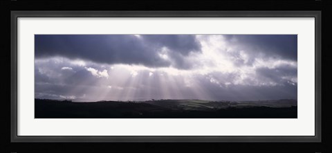 Framed Sunbeams radiating through dark clouds over rolling hills, Dartmoor, Devon, England Print