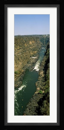 Framed Kayakers paddle down the Zambezi gorge away from the Victoria Falls, Zambia Print