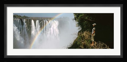 Framed Woman looking at a rainbow over the Victoria Falls, Zimbabwe Print