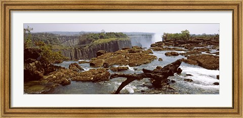 Framed Log on the rocks at the top of the Victoria Falls with Victoria Falls Bridge in the background, Zimbabwe Print