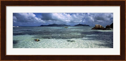 Framed Snorkeler in the clean waters on Anse Source d&#39;Argent beach, La Digue Island, Seychelles Print