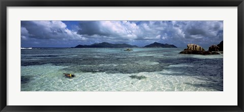 Framed Snorkeler in the clean waters on Anse Source d&#39;Argent beach, La Digue Island, Seychelles Print