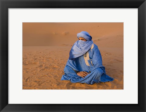 Framed Veiled Tuareg man sitting cross-legged on the sand, Erg Chebbi, Morocco Print