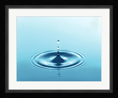 Framed Drops rising from ripples in blue water Print