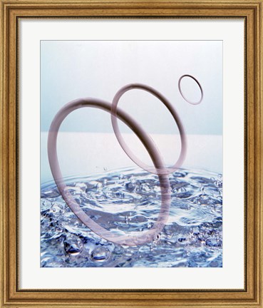 Framed Three opaque white circles floating away from churning water Print