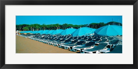 Framed Parasols with lounge chairs on a private beach in summer morning light, French Riviera, France Print