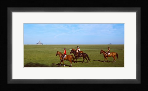 Framed Horseback riders in a field with Mont Saint-Michel island in background, Manche, Basse-Normandy, France Print