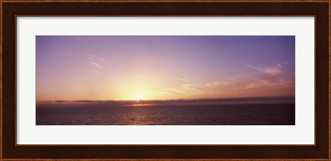 Framed Sun Setting Behind Clouds over the Sea Print