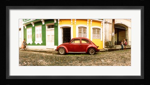 Framed Small old red car parked in front of colorful building, Pelourinho, Salvador, Bahia, Brazil Print
