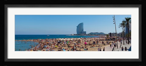 Framed Tourists on the beach with W Barcelona hotel in the background, Barceloneta Beach, Barcelona, Catalonia, Spain Print