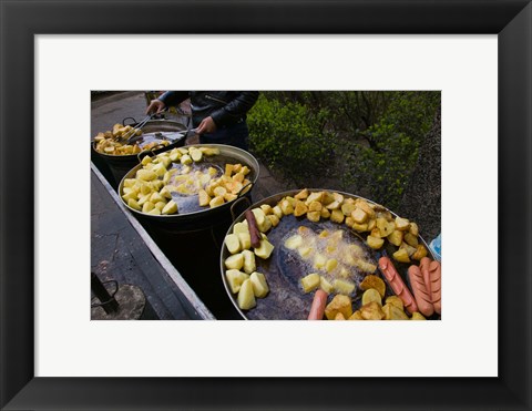 Framed Vendor selling deep fried potatoes and sausages at a sidewalk food stall, Old Town, Dali, Yunnan Province, China Print