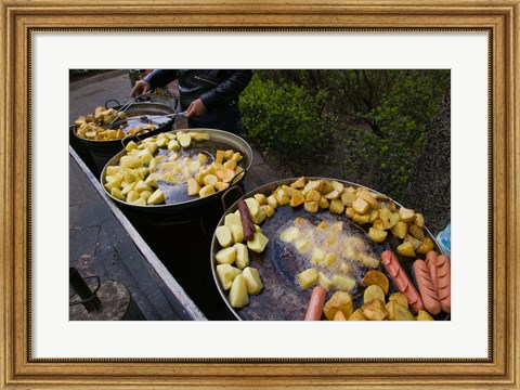 Framed Vendor selling deep fried potatoes and sausages at a sidewalk food stall, Old Town, Dali, Yunnan Province, China Print