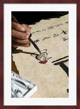 Framed Chinese calligrapher painting calligraphy on a paper at the Dongba Place, Old Town, Lijiang, Yunnan Province, China Print