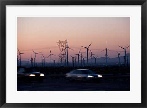 Framed Cars moving on road with wind turbines in background at dusk, Palm Springs, Riverside County, California, USA Print