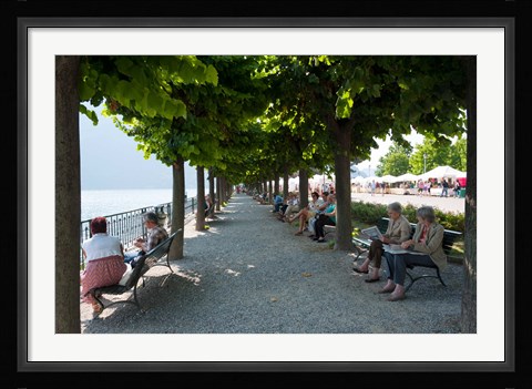 Framed People sitting on benches among trees at lakeshore, Lake Como, Cernobbio, Lombardy, Italy Print