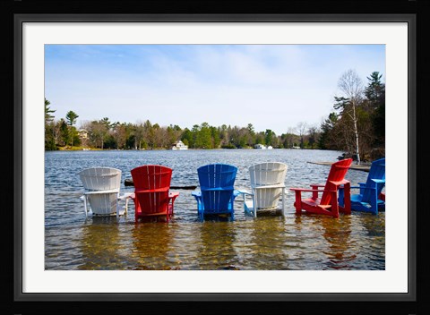 Framed Adirondack chairs partially submerged in the Lake Muskoka, Ontario, Canada Print