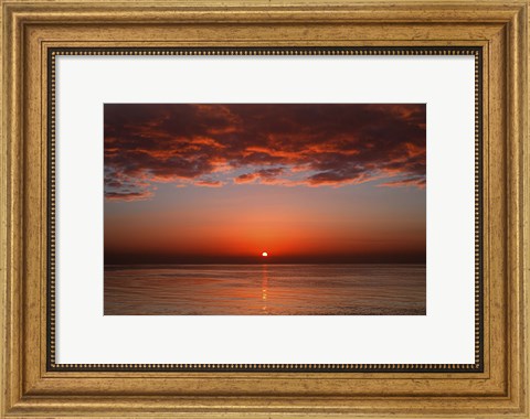 Framed layer of clouds is lit by the rising sun over Rio de la Plata, Buenos Aires, Argentina Print