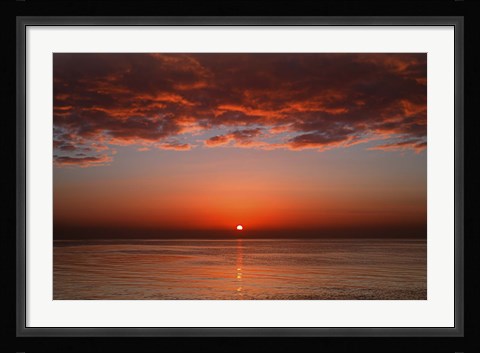 Framed layer of clouds is lit by the rising sun over Rio de la Plata, Buenos Aires, Argentina Print