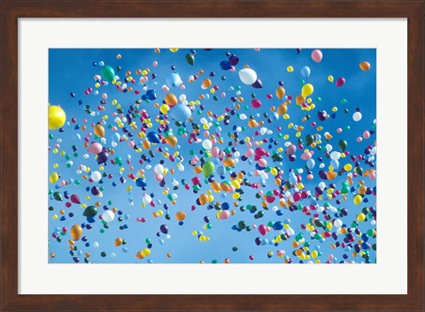 Framed Holiday balloons drifting into the sky Print