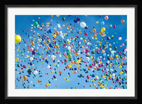 Framed Holiday balloons drifting into the sky Print