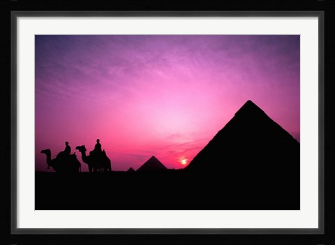 Framed Colorful Sunset Silhouetting Men and Camels at the Great Pyramids of Giza, Egypt Print