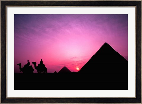 Framed Colorful Sunset Silhouetting Men and Camels at the Great Pyramids of Giza, Egypt Print