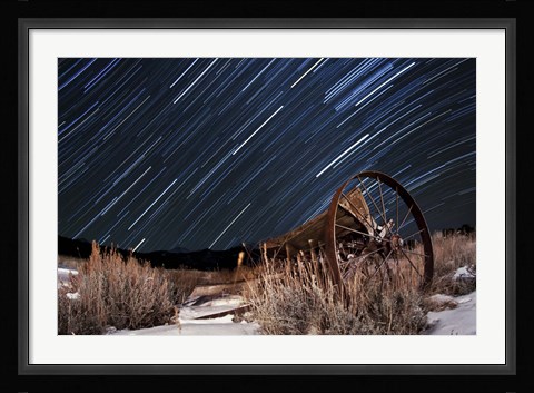 Framed Abandoned farm equipment against a backdrop of star trails Print