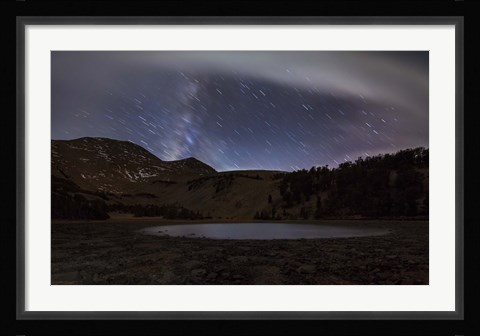 Framed Star trails and the blurred band of the Milky Way above a lake in the Eastern Sierra Nevada Print