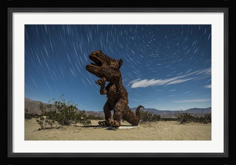 Framed Tyrannosaurus rex sculpture against a backdrop of star trails, California Print