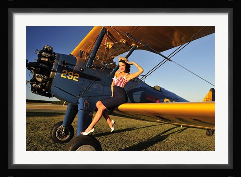 Framed 1940's style pin-up girl sitting on the wing of a Stearman biplane Print