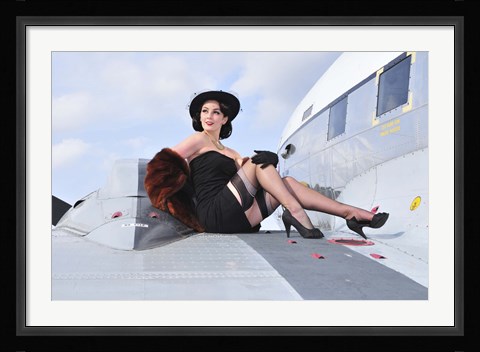 Framed Glamorous woman in 1940's style attire sitting on a vintage aircraft Print