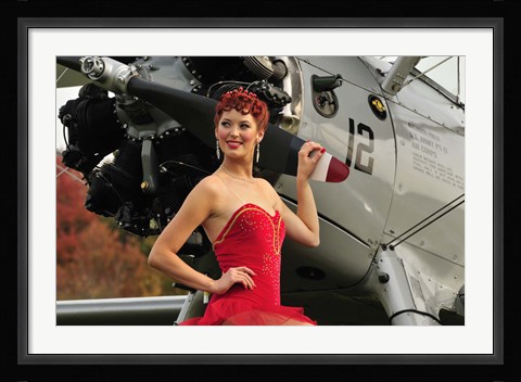 Framed Redhead pin-up girl in 1940's style dancer attire holding on to a vintage aircraft propeller Print