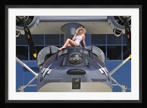 Framed Retro pin-up girl posing with a World War II era PBY Catalina seaplane Print