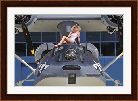 Framed Retro pin-up girl posing with a World War II era PBY Catalina seaplane Print