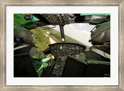 Framed Two instructor pilots practice low flying operations in a UH-1H Huey helicopter Print