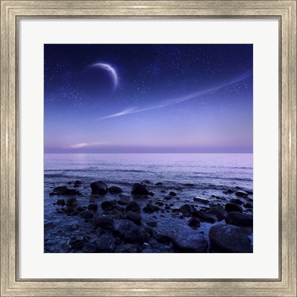Framed Moon rising over rocky seaside against starry sky Print