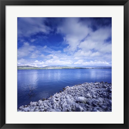 Framed Tranquil lake and rocky shore against cloudy sky, Sardinia, Italy Print