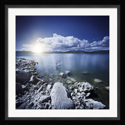Framed Tranquil lake and rocky shore with sun over horizon, Sardinia, Italy Print