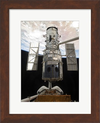 Framed Space Shuttle Atlantis&#39; arm lifts the Hubble Space Telescope from the cargo bay Print