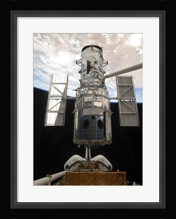Framed Space Shuttle Atlantis' arm lifts the Hubble Space Telescope from the cargo bay Print