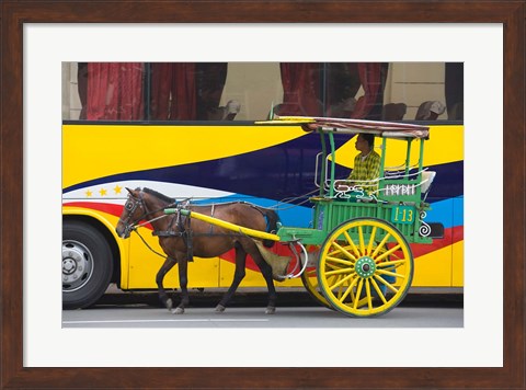 Framed Horse cart walk by colorfully painted bus, Manila, Philippines Print