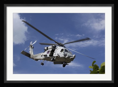 Framed Crew Chief looks out the side door of a helicopter in flight Print