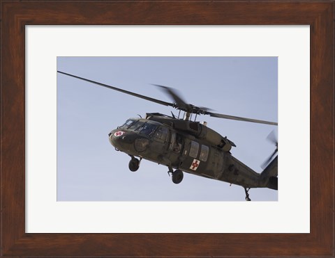 Framed UH-60 Blackhawk Medivac helicopter flies over Camp Warhorse Print