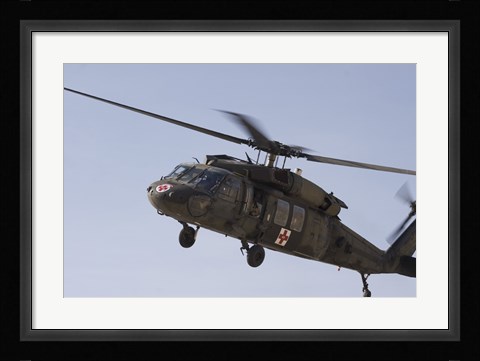 Framed UH-60 Blackhawk Medivac helicopter flies over Camp Warhorse Print
